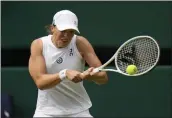  ?? ALASTAIR GRANT — THE ASSOCIATED PRESS ?? Poland's Iga Swiatek plays a return to Spain's Sara Sorribes Tormo during a women's singles match at the Wimbledon tennis championsh­ips in London on Wednesday.