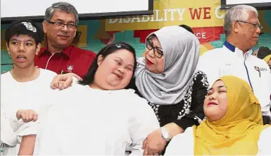  ??  ?? Up close and personal: Rohani (centre) with UiTM vice-chancellor Prof Emeritus Datuk Dr Hassan Said (right) and UiTM Dental Faculty Sungai Buloh Campus Rector Prof Dr Mohamed Ibrahim Abu Hassan (left) speaking with disabled youth after the launch of...