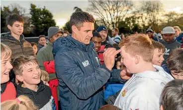  ?? GETTY IMAGES ?? Dan Carter signs autographs after helping Southbridg­e to their Coleman Shield win over West Melton.