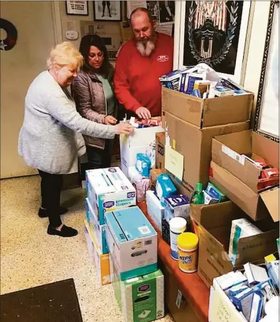  ?? Marine Veterans of Fairfield County / Contribute­d photo ?? The Marine Veterans of Fairfield County, located in Ridgefield, collected supplies to distribute to the Ukrainian people. Pictured, Shirley Wilken, left, Pam Petti and John Esposito take inventory of some of the supplies.