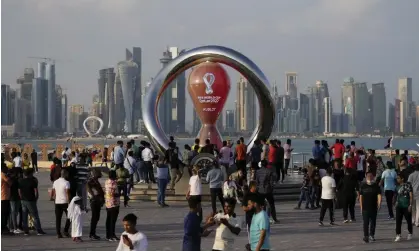  ?? Photograph: Hassan Ammar/AP ?? People gather around the official countdown clock in Doha as the World Cup edges ever closer.