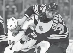  ?? BOB DECHIARA/USA TODAY SPORTS ?? Lightning forward Pat Maroon and Bruins defenseman Zdeno Chara fight during a March game.