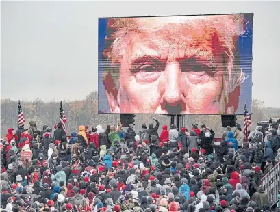  ?? NICOLE HESTER ANN ARBOR NEWS VIA THE ASSOCIATED PRESS ?? Trump supporters at a campaign event on Tuesday in Lansing, Mich.. were for the most part unmasked, like their leader.