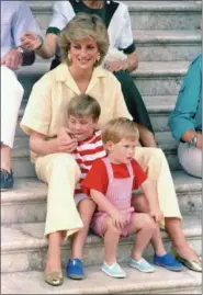  ?? JOHN REDMAN — THE ASSOCIATED PRESS FILE ?? Britain’s Princess Diana of Wales smiles as she sits with her sons, Princes Harry, front, and William, on the steps of the Royal Palace on the island of Mallorca, Spain, where the British Royal family is on holiday with the Spanish King Juan Carlos and...