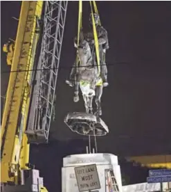  ??  ?? NEW ORLEANS: A statue of Confederat­e general P G T Beauregard is removed just after 3 am Central Standard Time yesterday from the entrance to City Park. — AP