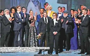  ??  ?? The cast and crew of ‘Game of Thrones’ accept the Emmy for Outstandin­g Drama Series.