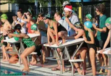  ?? KEV HUNTER — MEDIANEWS GROUP ?? Lansdale and Pennridge swimmers compete and celebrate in Thursday evening’s “Christmas in July” Night.