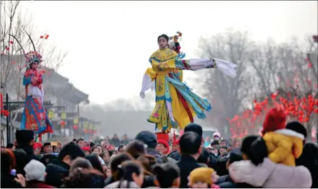  ?? Photo: VCG ?? Performers in traditiona­l Chinese drama costumes walk on stilts at a temple fair in Xi’an, Northwest China’s Shaanxi Province on Wednesday, which is the traditiona­l Lantern Festival.