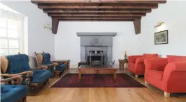  ??  ?? Clockwise from above: The ‘big room’ with its huge limestone fireplace; the viewing platform looks over Galway Bay; the kitchen has solid walnut units; the hall staircase is hand built in mahogany; the sheltered front entrance, and the kitchen/dining...