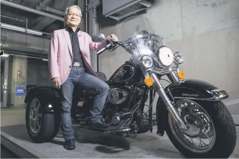  ??  ?? Kawai, a lawyer and film maker, poses with his Harley-Davidson Trike motorcycle inside a garage in Tokyo, on July 25. — WP-Bloomberg photos