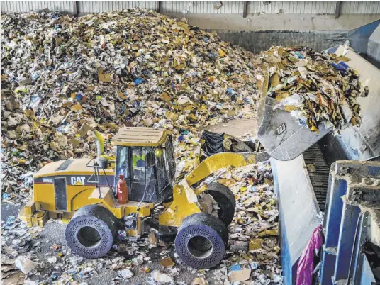  ?? L.E. Baskow Las Vegas Review-Journal @Left_Eye_Images ?? Recyclable­s are loaded at metering bins at Republic Services’ recycling center in North Las Vegas.