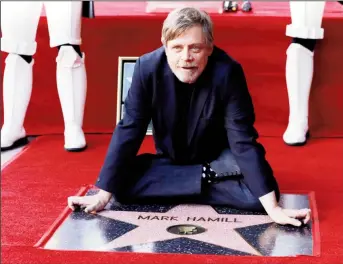  ?? (Reuters photo) ?? Actor Mark Hamill poses on his star after it was unveiled on the Hollywood Walk of Fame in Los Angeles, California, U.S., March 8, 2018.