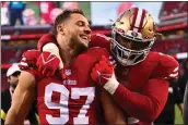  ?? JOSE CARLOS FAJARDO — BAY AREA NEWS GROUP ?? The 49ers' Nick Bosa (97) and Trent Williams (71) celebrate after defeating the New Orleans Saints during their game at Levi's Stadium in Santa Clara on Nov. 27.