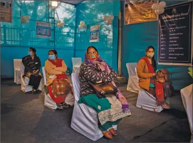  ?? (AP/Altaf Qadri) ?? People participat­ing in a coronaviru­s vaccine delivery system trial wait for their turn at a vaccinatio­n center Saturday in New Delhi.