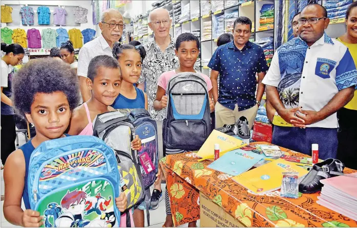  ?? Picture: FILE/RAMA ?? Sitiveni Yaqona (back left), Ross McDonald and Krishna Raju of Masonic Lodge of Fiji give school stationery, bags and other school items to the students and teachers from Lau earlier this year for back to school. The teachers and students received the items from CK’s Suva Bargain Centre.