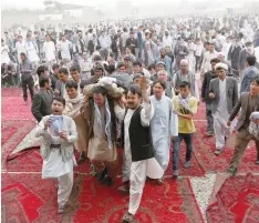  ?? — Reuters ?? Men carry the coffin of a victim before the burial ceremony, a day after a militant attack in Kabul, on Sunday.