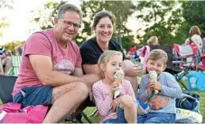  ??  ?? Elouisa and Theo enjoy their ice creams with parents Greg and Heidi Law.