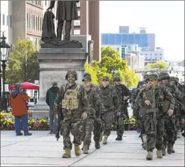  ?? Matthew Dae Smith L ansing State Journal ?? MICHIGAN protesters march toward the Capitol in Lansing last month to decry coronaviru­s restrictio­ns that some state conservati­ves have called “tyranny.”