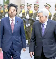  ??  ?? Abe (left) walks with Abbas during a welcome ceremony in the West Bank city of Ramallah. — AFP photo