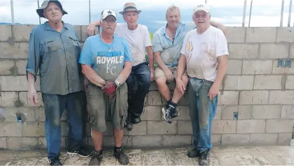  ??  ?? Arnold Harder, left, Garry Koop, Bill Zacharias, Menno Zacharias and Armin Krahn travelled to Puerto Rico to help with reconstruc­tion efforts following Hurricane Irma.