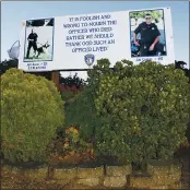  ?? COURTESY PHOTO — BILL YUEN ?? The small billboard tribute sign to the late Vallejo officers Jeff Azuar and Jim Capoot was demolished late last week by vandalism.