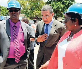  ?? PHOTO BY CHRISTOPHE­R SERJU ?? Prime Minister Andrew Holness (centre) engages Karl Blake, councillor for the Greenwich Town division, and Dr Angela Brown Burke, member of parliament for South Western St Andrew, about his plans for developmen­t of the constituen­cy, following their...