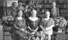  ?? COURTESY OF VERMILION HISTORY MUSEUM ?? Photo of six women in the newly built library on Grand Street in Vermilion in 1934. Previous library board member Bessie Roscoe, middle front row, served on the board from 1918 to her death in 1946. She played a large part in acquiring the library from the Village of Vermilion.