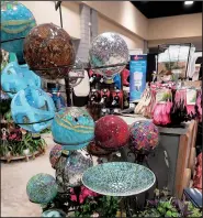  ?? Special to the Democrat-Gazette/JANET B. CARSON ?? Gazing balls and mosaic birdbaths beckon shoppers at the 2017 Arkansas Flower and Garden Show.