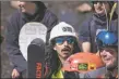  ?? JEANS PINEDA/Taos News ?? Patch, dressed as a constructi­on worker, listens to the instructio­ns of the pond skim from one of the judges on Saturday (April 2).