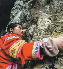  ?? PROVIDED TO CHINA DAILY ?? Luo Dengping, 40-year-old “spider-woman” of the Miao ethnic group, performs rock climbing for tourists at Getu River Scenic Spot in Guizhou province.