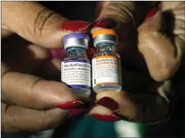  ?? ROGELIO V. SOLIS — THE ASSOCIATED PRESS FILE ?? A nurse holds a vial of the Pfizer COVID-19vaccine for children ages 5to 11, right, and a vial of the vaccine for adults, which has a different colored label, at a vaccinatio­n station in Jackson, Miss.