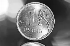  ?? — Reuters photo ?? A Russian one rouble coin is seen in this picture illustrati­on. Russia’s CPI rose slightly above the central bank target of four per cent in 2018, the statistics service’s preliminar­y data showed.