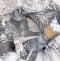  ?? ?? HELP ON WAY: A kid named Ahmed is glimpsed (left) through the mangled wreckage of his family’s home north of Aleppo, Syria, on Monday before pickax-wielding rescuers pull him to safety (below).