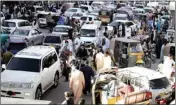  ?? PTI ?? People rush to shop for the Eid holiday that marks the end of the Muslim holy fasting month of Ramadan after the government relaxed a weeks-long lockdown that was enforced to help curb the spread of the Coronaviru­s, in Quetta, Pakistan, Monday