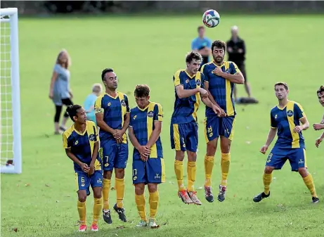  ?? SHANE WENZLICK / PHOTOTEK.NZ ?? Manurewa AFC’s players try to block a free kick. They lost 3-0 to Onehunga Sports on April 25.