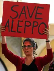  ?? AP ?? AN ACTIVIST appeals for a cessation of hostilitie­s in the rebel-held Syrian city of Aleppo.