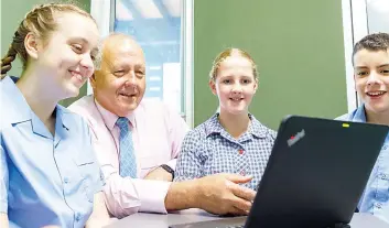  ?? ?? Drouin Secondary College’s Year 7 Learning Culture Leader, Mr Andrew Walsh (second from left), works with students Hannah Munckhof, Eve Long and Reuben Walker, supporting them to learn and realise their own personal learning goals.