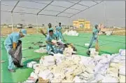  ??  ?? Workers clean the Yamuna floodplain where the Art of Living organised World Culture Festival in March. SUSHIL KUMAR/HT FILE