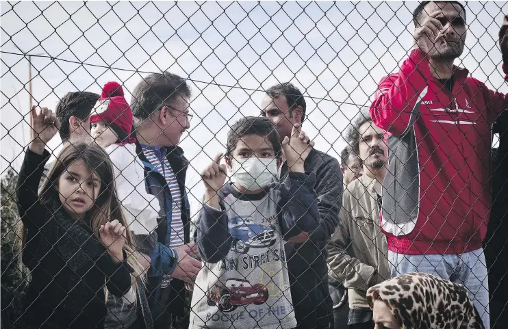  ?? — GETTY IMAGES ?? Migrants at a camp in Athens, Greece, on Monday. A survey found that Canadians have an “impressive” knowledge of Canada’s refugee system.