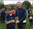  ??  ?? An Tochar’s Darragh Fee collects his Wicklow People sponsored Man of the Match award from Brendan Lawrence.