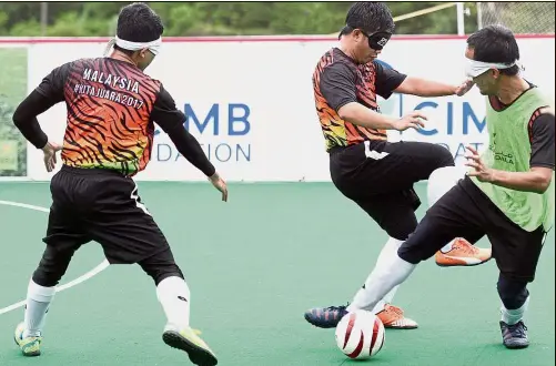  ??  ?? Hard at work: The national blind football players going through the paces during a training session at Pusat Sukan UPM Serdang.