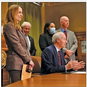  ?? (Arkansas Democrat-Gazette/Stephen Swofford) ?? Gov. Asa Hutchinson, joined by Arkansas lawmakers and teachers, holds a news conference Monday at the state Capitol in Little Rock to sign the two measures to increase the state’s median teacher salary.