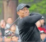  ?? AP ?? Tiger Woods watches his tee shot on the 11th hole .