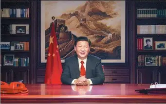  ?? XINHUA ?? President Xi Jinping delivers his New Year address on Sunday. It was aired on television, radio and the internet.