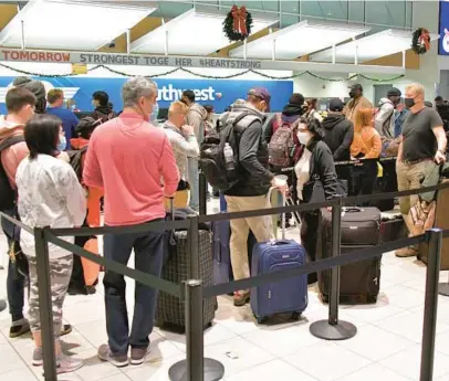  ?? AMY DAVIS/BALTIMORE SUN ?? The Southwest Airlines check-in counter at BWI Thurgood Marshall Airport was busy by pre-dawn Jan. 2 of last year, as many holiday travelers headed home.
