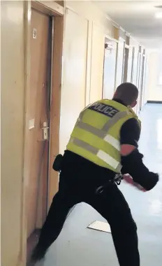  ??  ?? Warrant An officer smashes down a door during the first of last week’s two operations in Cambuslang