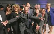  ?? Dan Haar/Hearst Connecticu­t Media ?? Shawn Wooden, center, hams it up with friends including U.S. House Minority Leader Hakeem Jeffries, D-NY, behind Wooden, at a gala in Wooden's honor Friday at Dunkin' Donuts Park in Hartford.