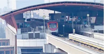  ?? AFP ?? An orange line metro train (OLMT) stands parked at a station after train services got suspended due to a countrywid­e power outage in Lahore on Monday. —