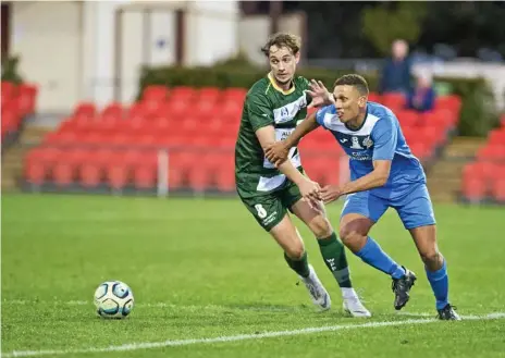  ?? Photo: Nev Madsen ?? CLOSE CONTROL: South West Queensland Thunder striker Travis Cooper (right) attempts to work his way past Western Pride’s Nielen Brown.