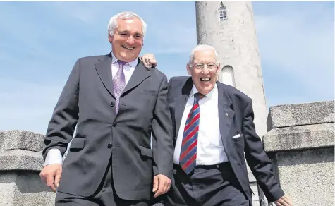  ?? PHOTO: GARETH CHANEY COLLINS ?? Reaching out: Former Taoiseach Bertie Ahern and former DUP leader Dr Ian Paisley during a vist to Glasnevin Cemetery, Dublin, in 2010.